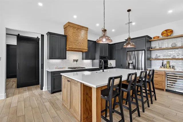 a kitchen with refrigerator cabinets and wooden floor