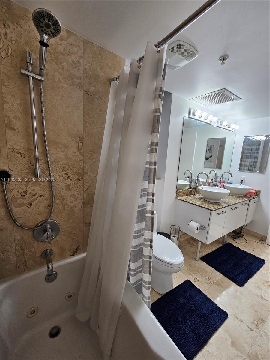 41 Southeast 5th Street, Unit 1517 Miami, FL 33131 - Photo 24 of 50 a bathroom with a sink toilet and shower