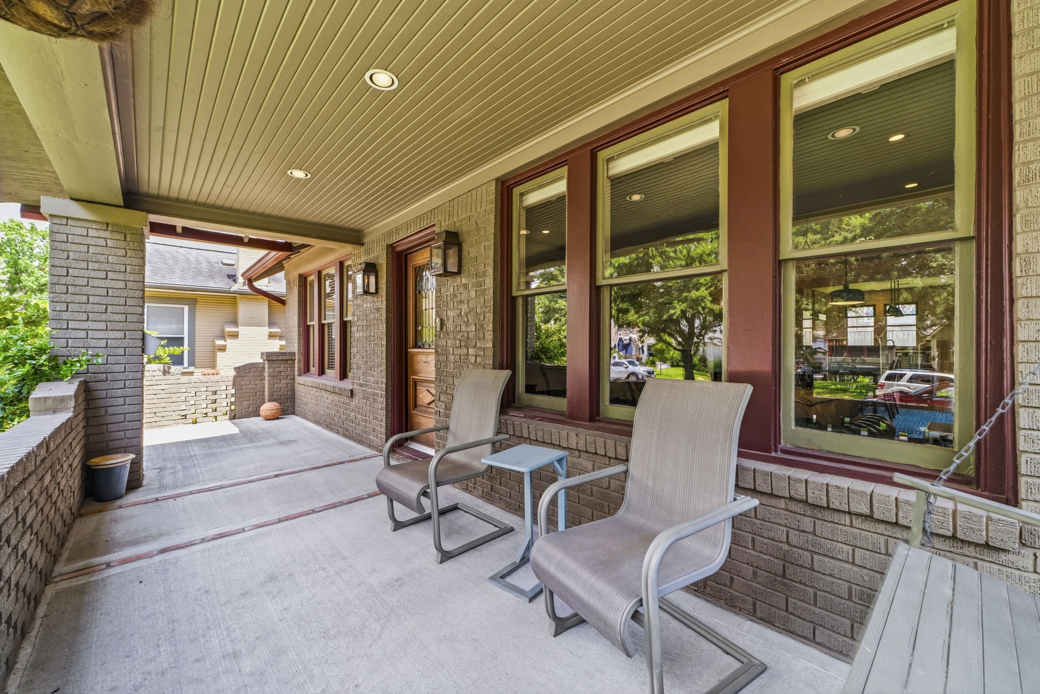1521 Kipling Street Houston, TX 77006 - Photo 7 of 35 Charming covered front porch with brick accents and ample seating space, perfect for relaxing and enjoying the neighborhood view.