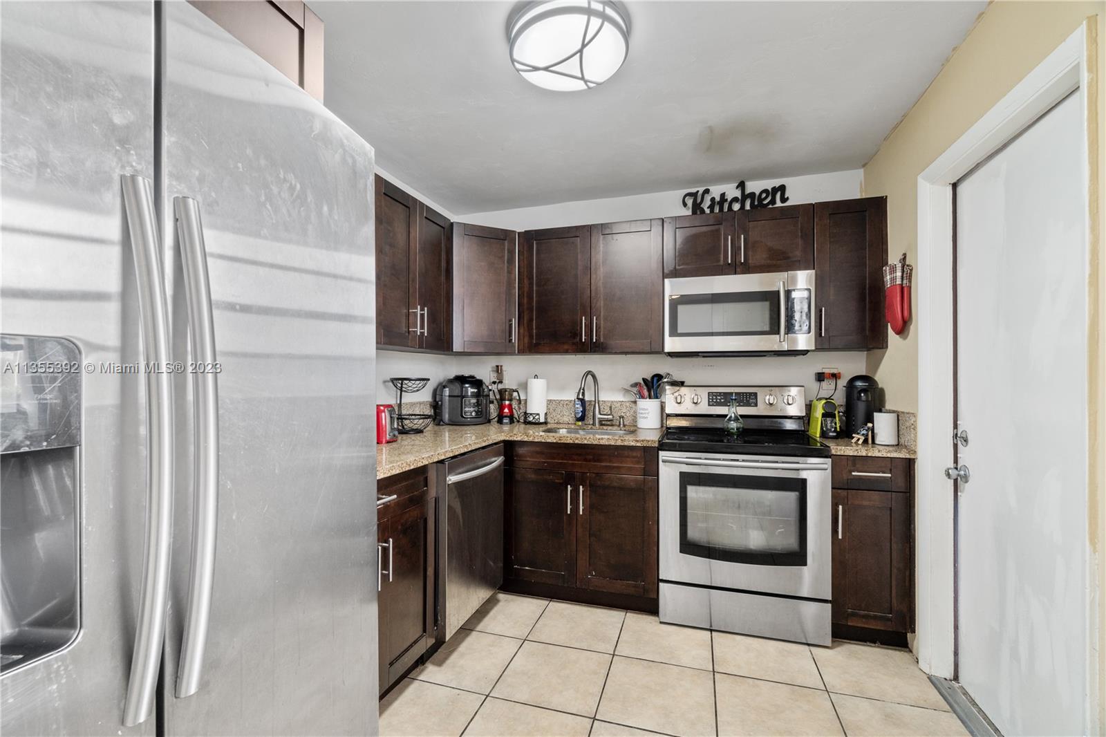 a kitchen with stainless steel appliances granite countertop a stove top oven a sink and dishwasher