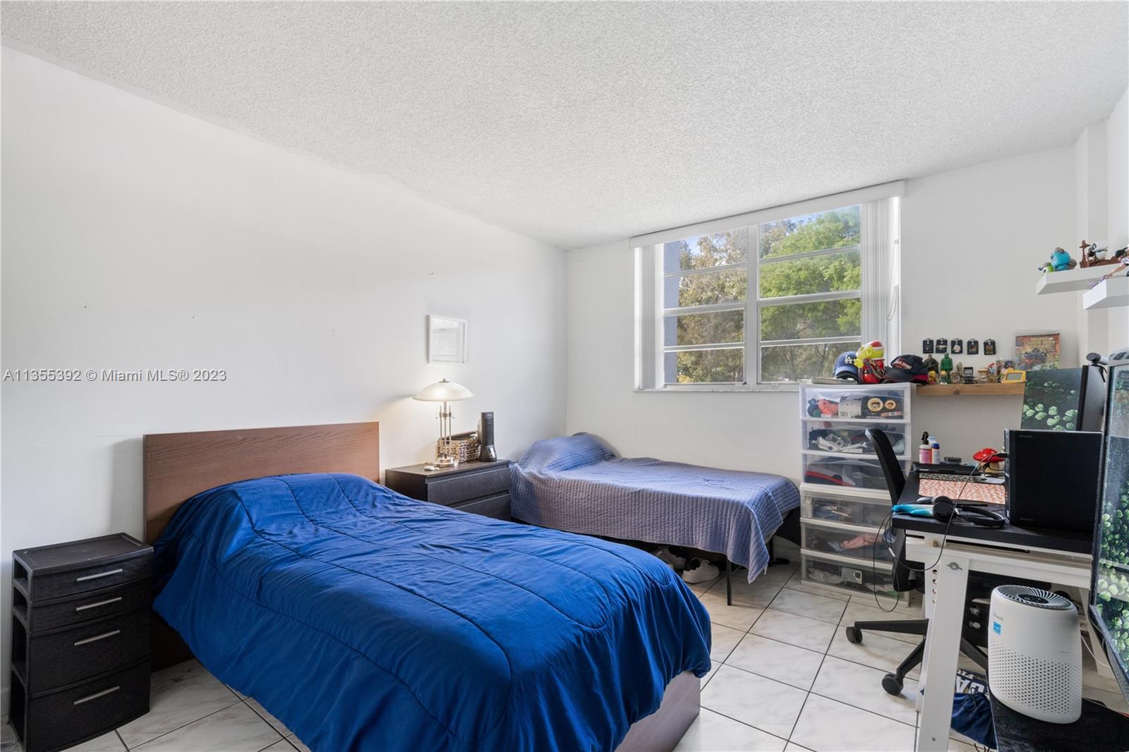 14140 Southwest 84th Street, Unit 208H Miami, FL 33183 - Photo 11 of 29 a bedroom with two beds and a window
