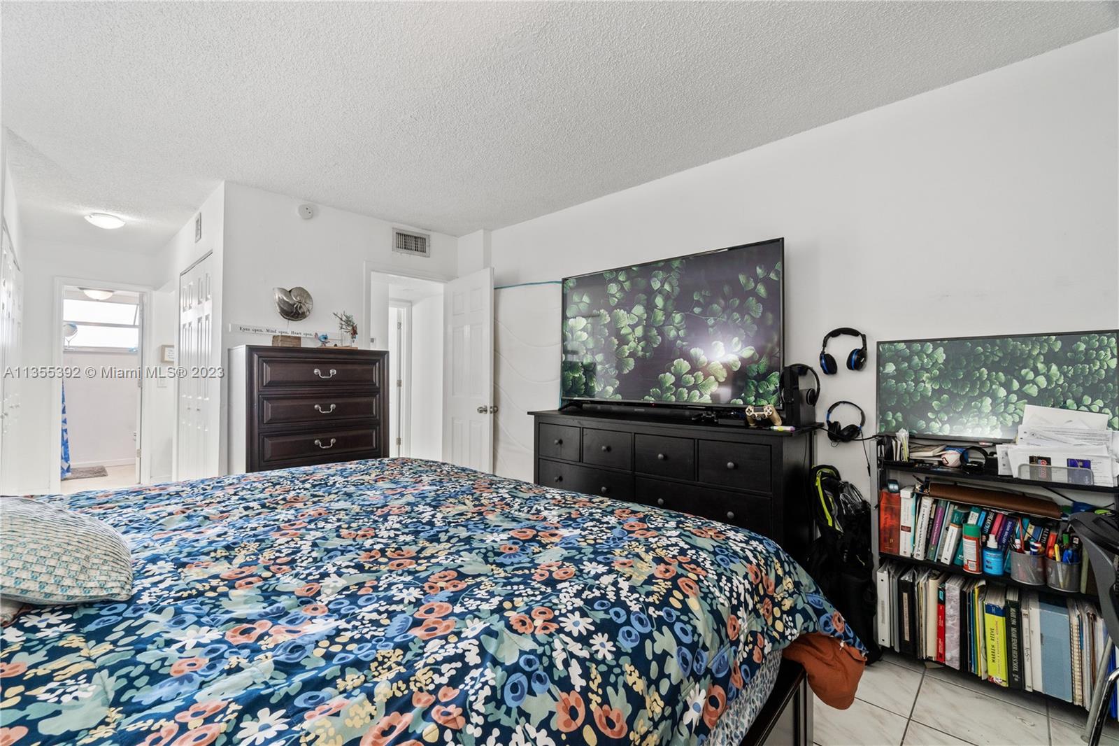 14140 Southwest 84th Street, Unit 208H Miami, FL 33183 - Photo 13 of 29 a bedroom with a bed and a flat screen tv