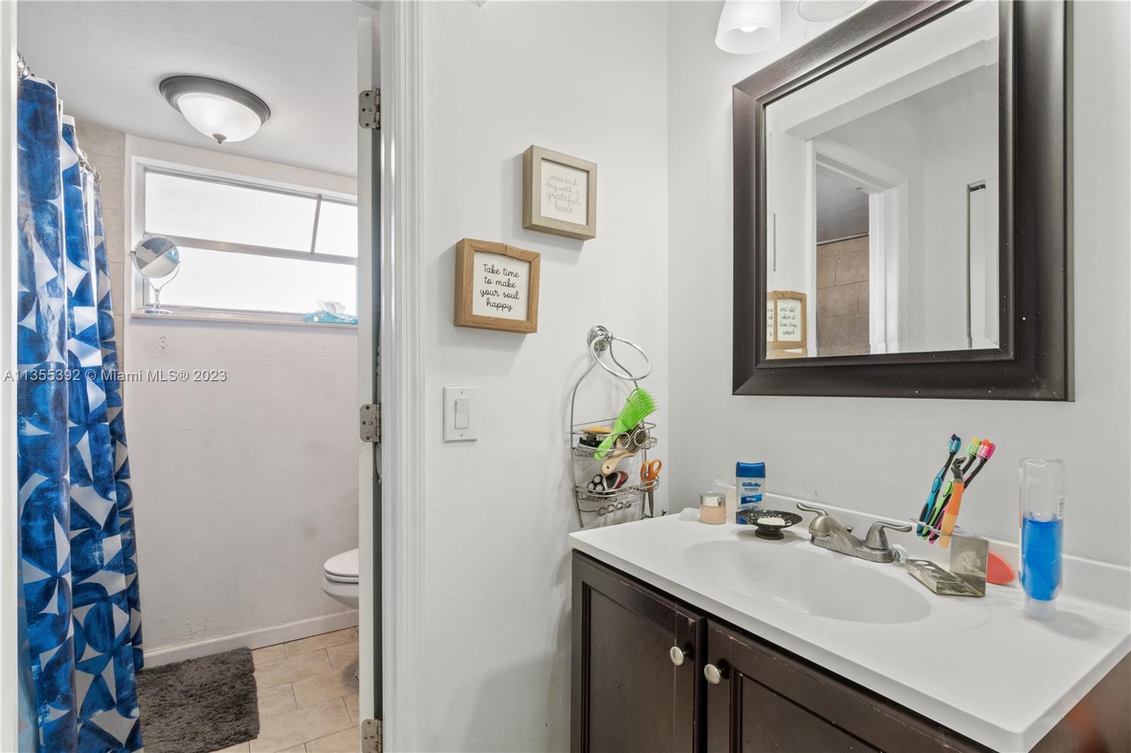 14140 Southwest 84th Street, Unit 208H Miami, FL 33183 - Photo 14 of 29 a bathroom with a sink toilet and mirror