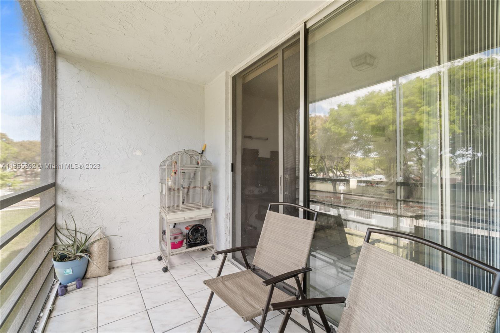 14140 Southwest 84th Street, Unit 208H Miami, FL 33183 - Photo 17 of 29 a room with furniture and a large window