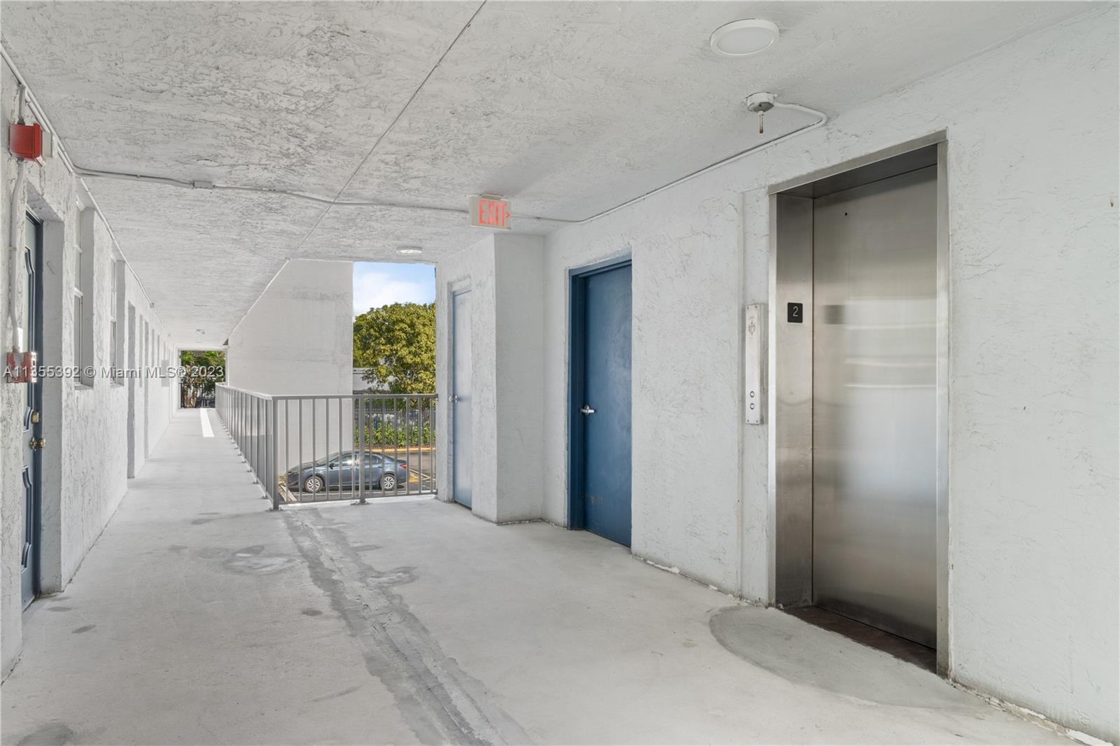 14140 Southwest 84th Street, Unit 208H Miami, FL 33183 - Photo 20 of 29 a view of a hallway with wooden chairs