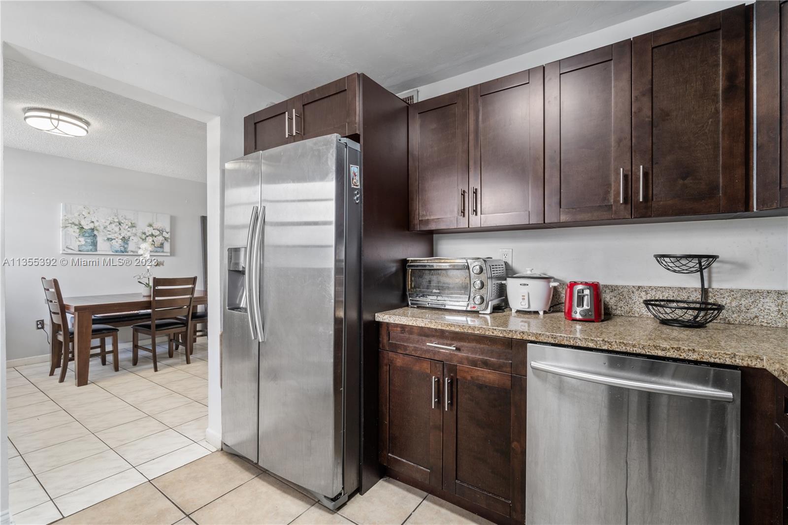 14140 Southwest 84th Street, Unit 208H Miami, FL 33183 - Photo 2 of 29 a kitchen with stainless steel appliances granite countertop a refrigerator sink and cabinets