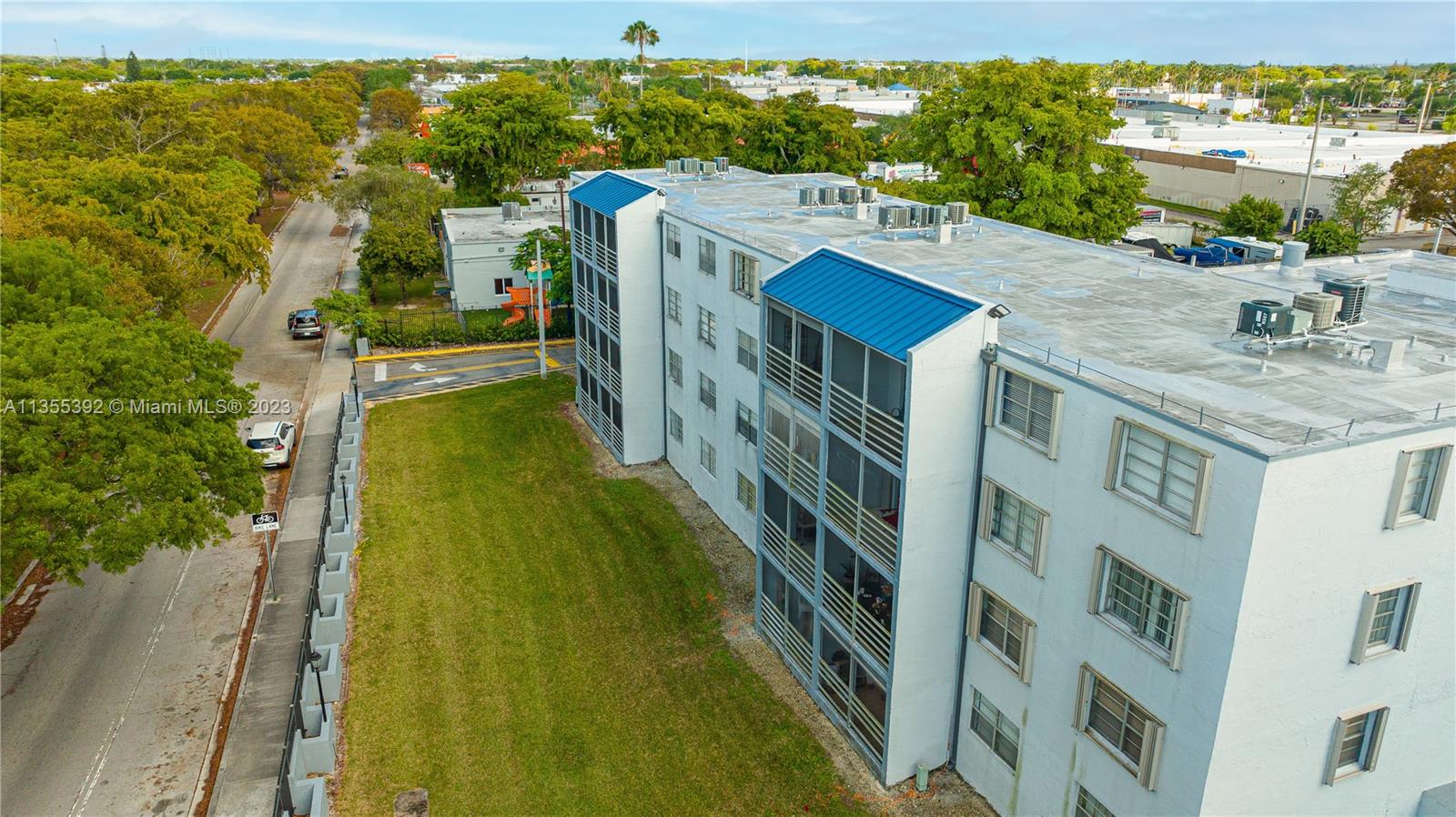 14140 Southwest 84th Street, Unit 208H Miami, FL 33183 - Photo 27 of 29 a view of a residential apartment building with a yard