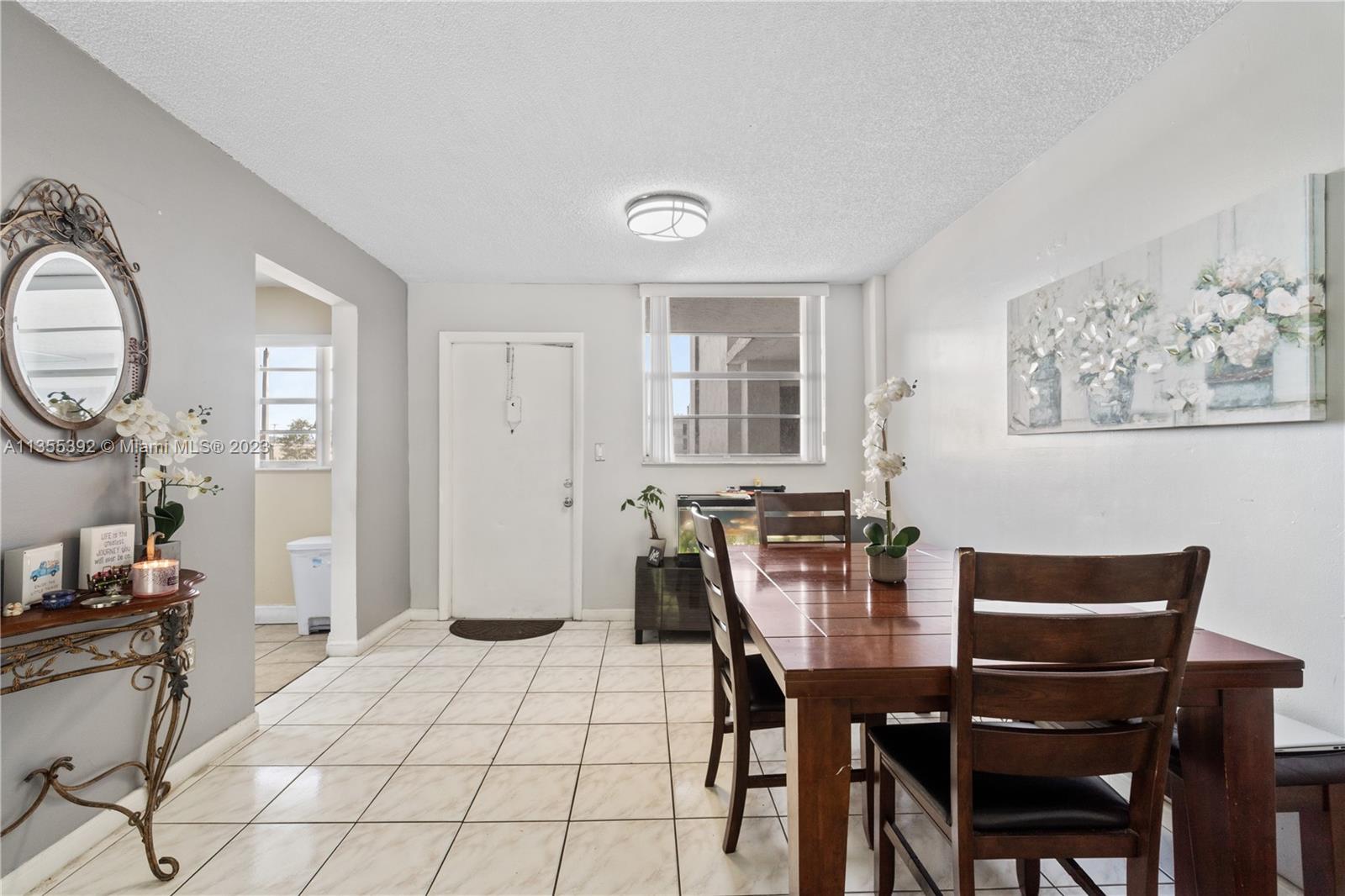 14140 Southwest 84th Street, Unit 208H Miami, FL 33183 - Photo 4 of 29 a view of a dining room with furniture and chandelier