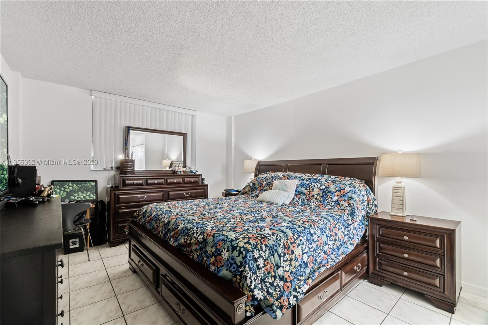 14140 Southwest 84th Street, Unit 208H Miami, FL 33183 - Photo 9 of 29 a bedroom with a bed and dresser