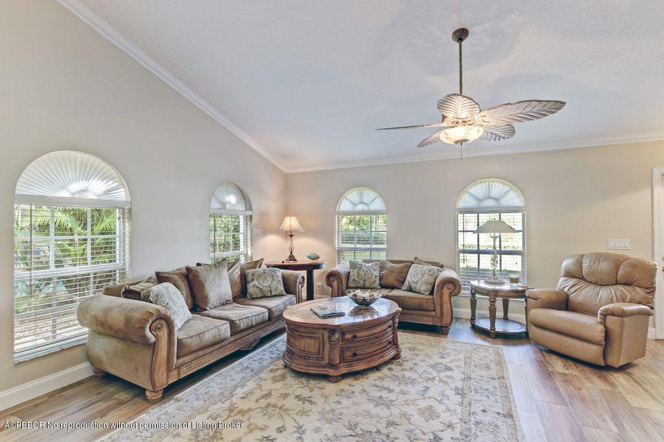 18905 Southeast County Line Road Jupiter, FL 33469 - Photo 11 of 74 a living room with furniture chandelier and a large window