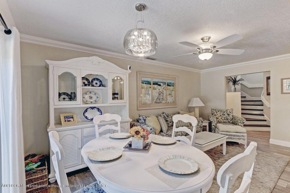 18905 Southeast County Line Road Jupiter, FL 33469 - Photo 19 of 74 a view of a dining room with furniture a chandelier and wooden floor