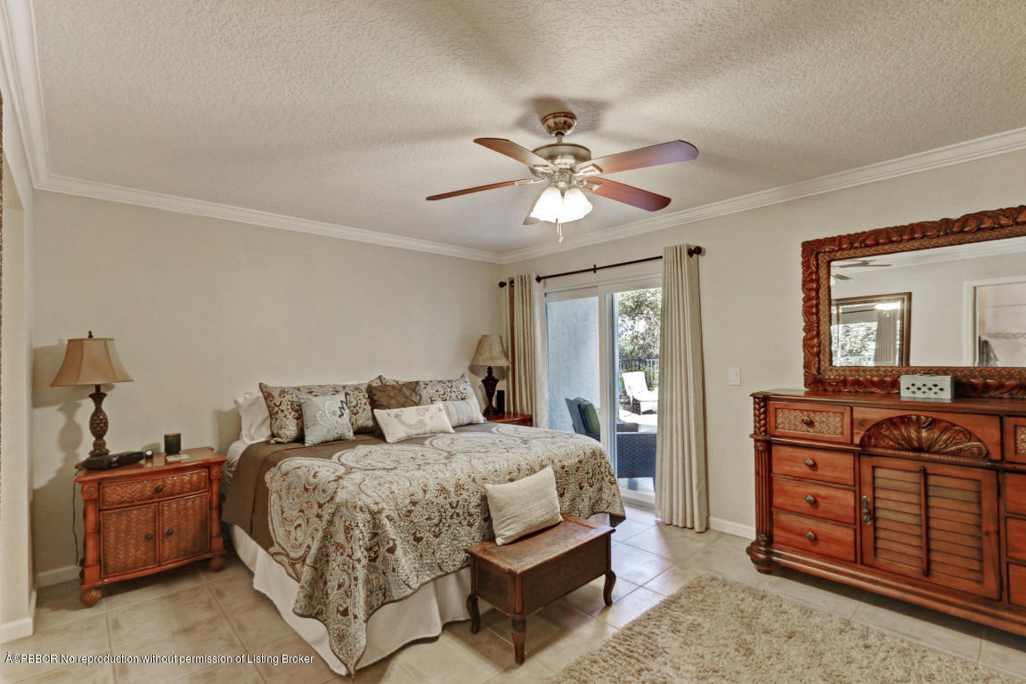 18905 Southeast County Line Road Jupiter, FL 33469 - Photo 26 of 74 a bedroom with a bed and a dresser