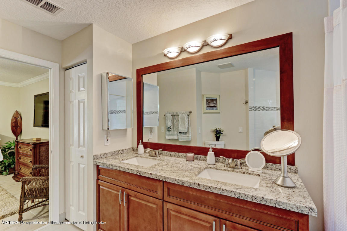 18905 Southeast County Line Road Jupiter, FL 33469 - Photo 30 of 74 a bathroom with a granite countertop sink and a mirror