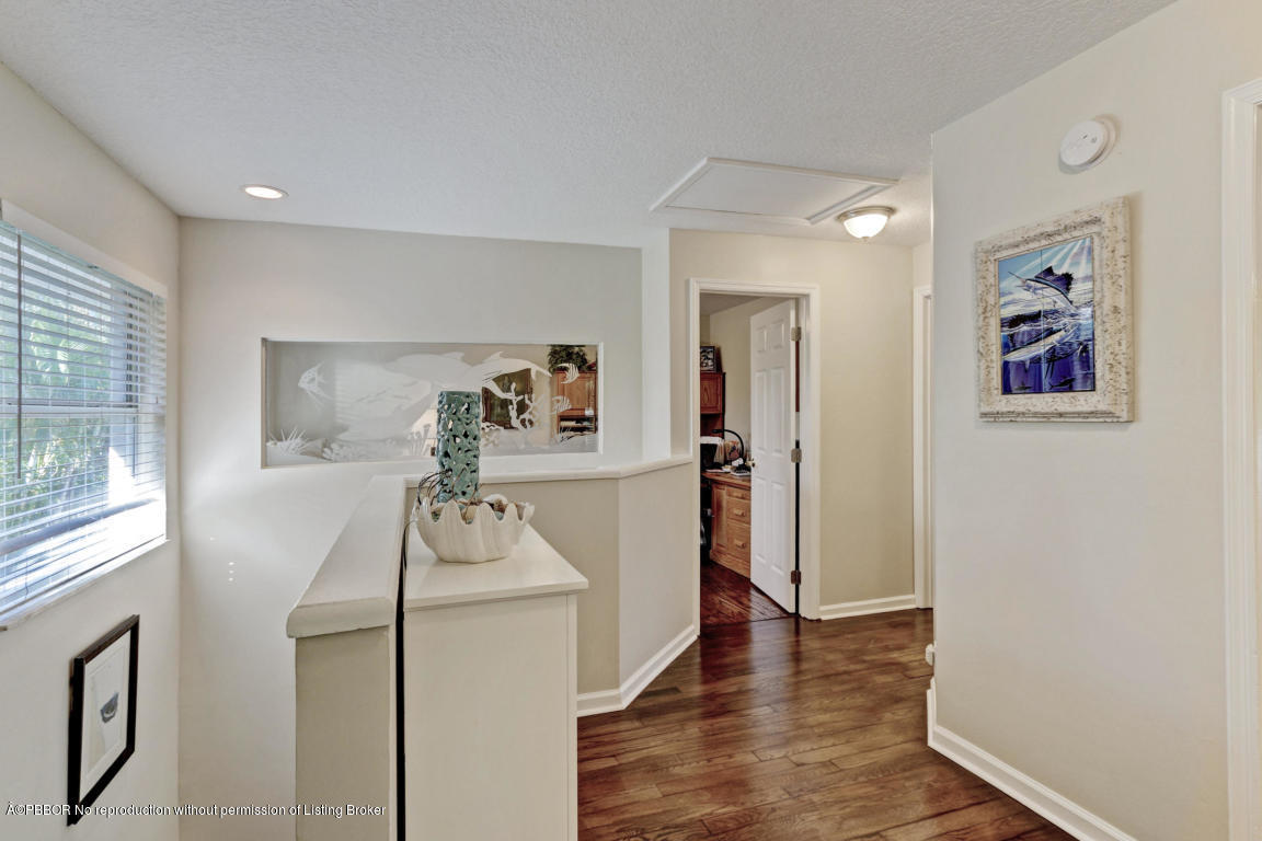 18905 Southeast County Line Road Jupiter, FL 33469 - Photo 32 of 74 a room with furniture and a wooden floor