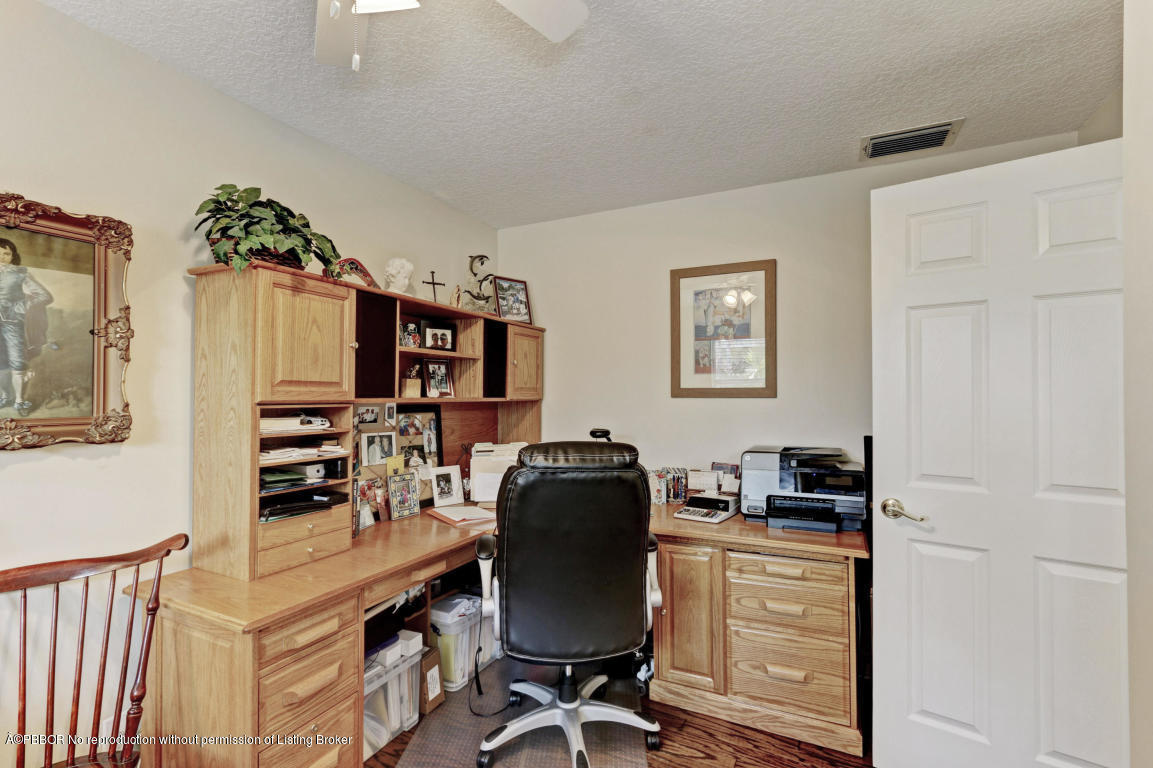 18905 Southeast County Line Road Jupiter, FL 33469 - Photo 37 of 74 a view of a workspace with furniture and gym equipment