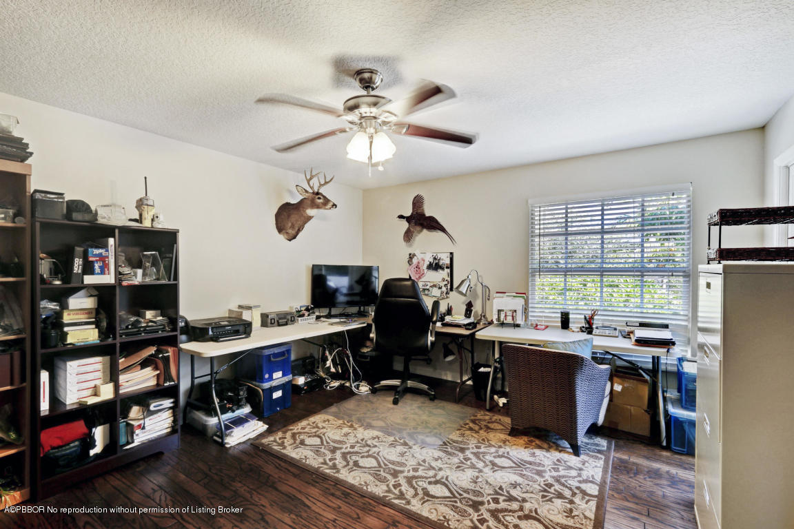 18905 Southeast County Line Road Jupiter, FL 33469 - Photo 40 of 74 a view of a workspace with furniture and a window