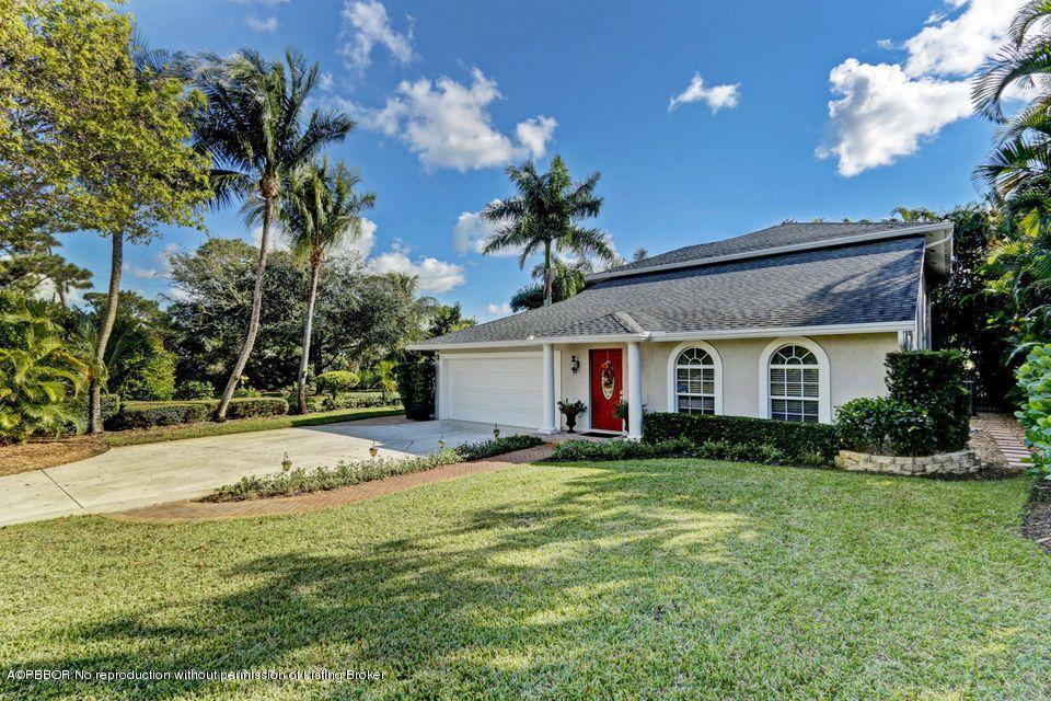 18905 Southeast County Line Road Jupiter, FL 33469 - Photo 5 of 74 a front view of house with yard and trees