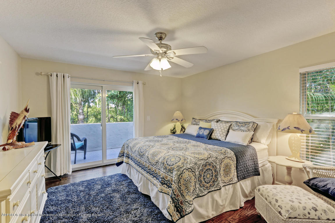 18905 Southeast County Line Road Jupiter, FL 33469 - Photo 42 of 74 a bedroom with a bed and a couch