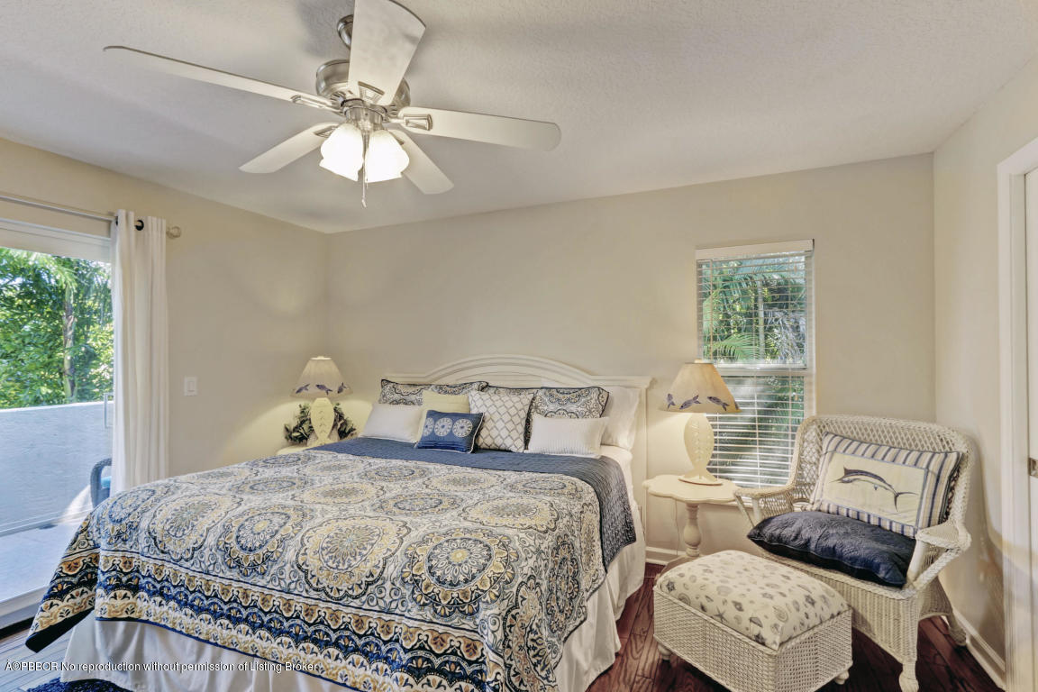 18905 Southeast County Line Road Jupiter, FL 33469 - Photo 43 of 74 a bedroom with a bed and a chandelier