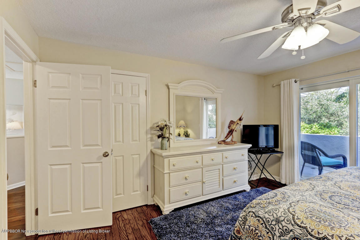 18905 Southeast County Line Road Jupiter, FL 33469 - Photo 44 of 74 a view of a bedroom with a bed and wooden floor