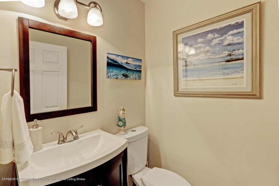 18905 Southeast County Line Road Jupiter, FL 33469 - Photo 49 of 74 a bathroom with a toilet a sink and mirror