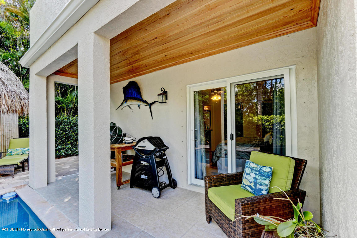 18905 Southeast County Line Road Jupiter, FL 33469 - Photo 54 of 74 a wooden bench sitting in front of a building