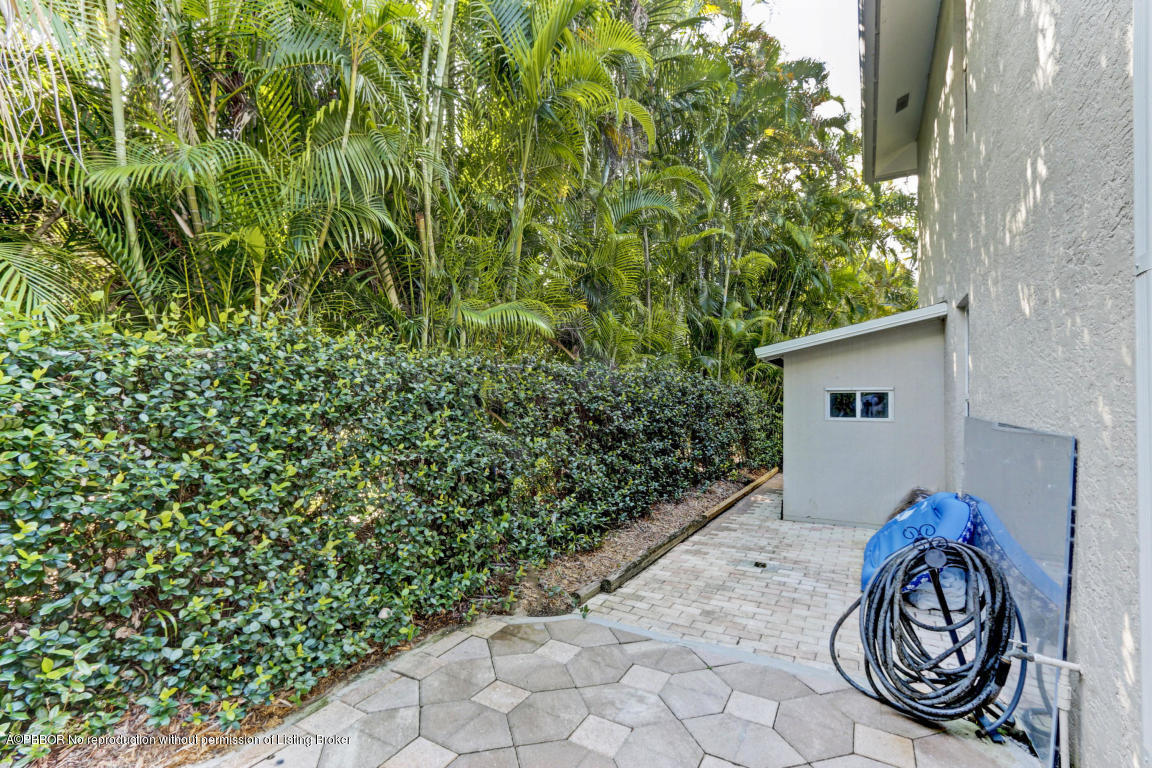 18905 Southeast County Line Road Jupiter, FL 33469 - Photo 60 of 74 a front view of a house with garden