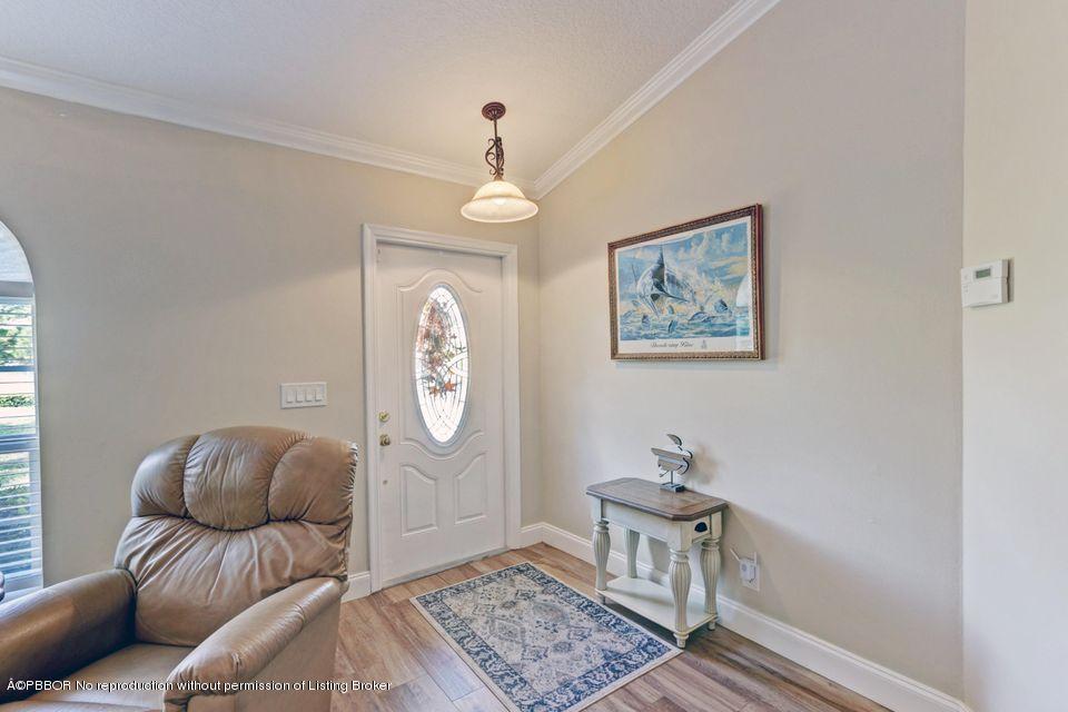 18905 Southeast County Line Road Jupiter, FL 33469 - Photo 7 of 74 a living room with furniture a window and a table
