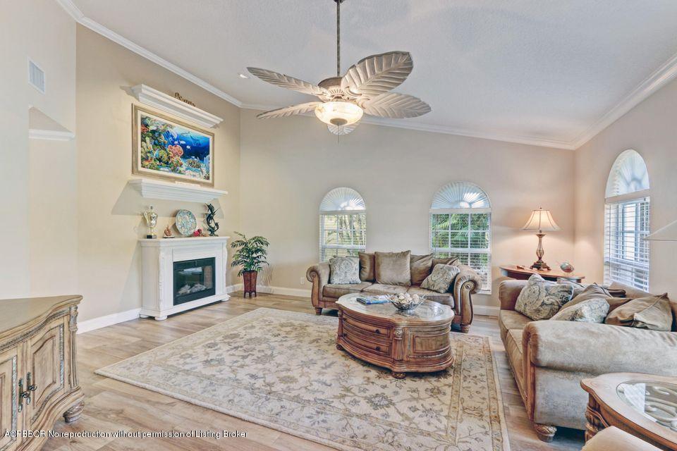 18905 Southeast County Line Road Jupiter, FL 33469 - Photo 8 of 74 a living room with furniture a fireplace and a flat screen tv