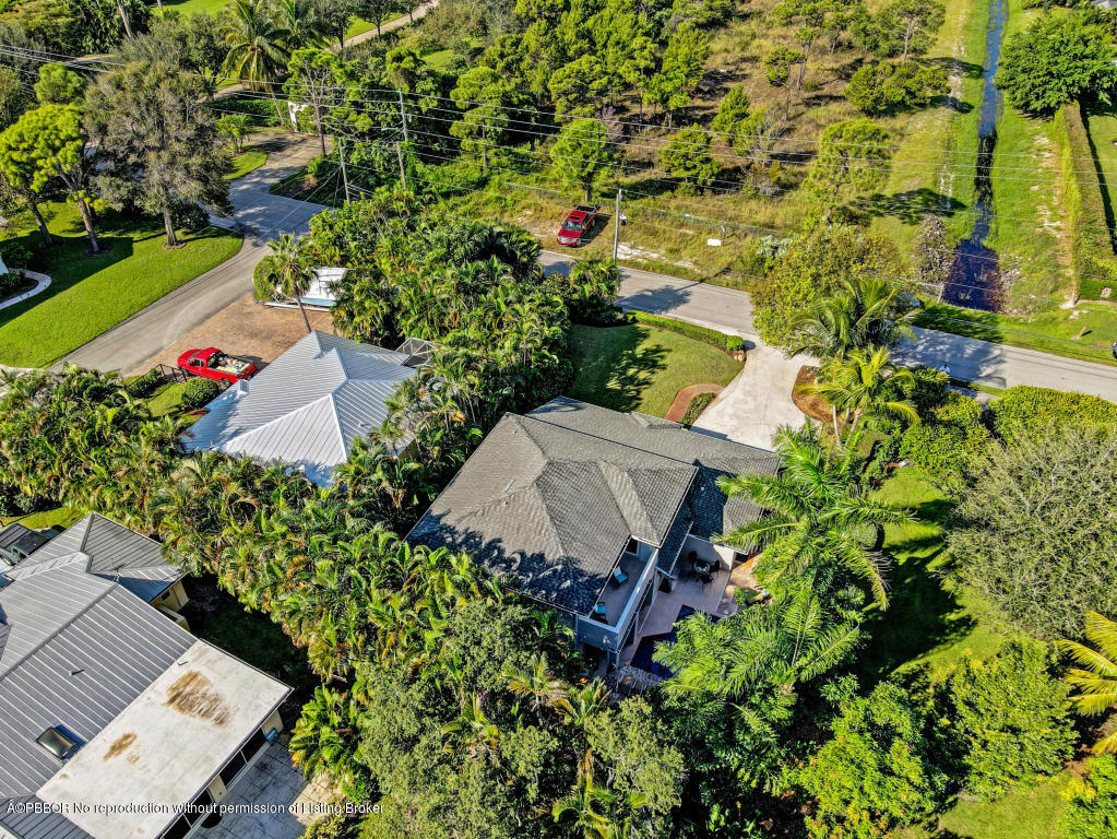 18905 Southeast County Line Road Jupiter, FL 33469 - Photo 73 of 74 an aerial view of a house with a yard and garden