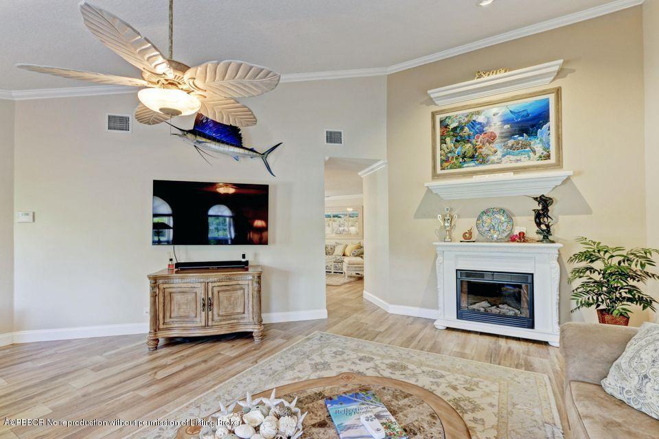 18905 Southeast County Line Road Jupiter, FL 33469 - Photo 9 of 74 a living room with furniture a flat screen tv and a fireplace