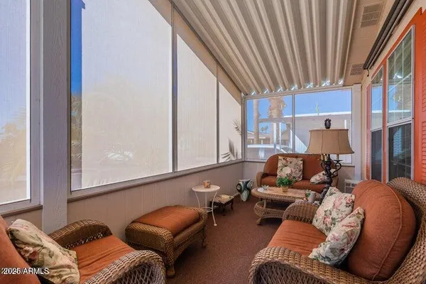 a kitchen with stainless steel appliances kitchen island granite countertop a refrigerator a stove a sink a dining table and chairs with wooden floor