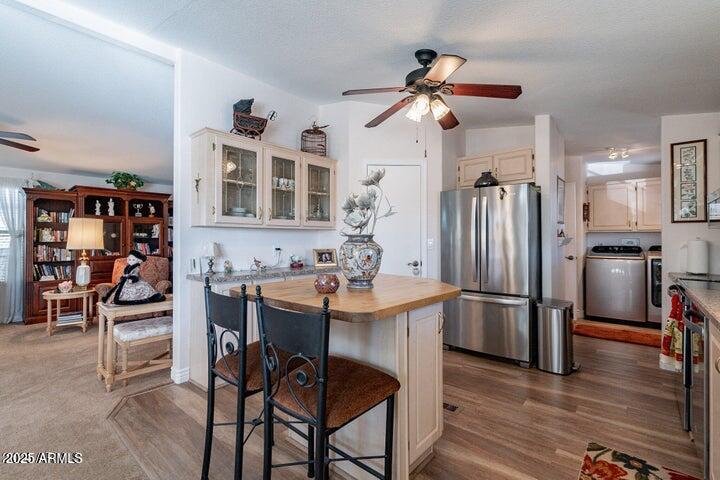 201 South Greenfield Road, Unit 176 Mesa, AZ 85206 - Photo 22 of 61 a kitchen with stainless steel appliances kitchen island granite countertop a table chairs and a refrigerator
