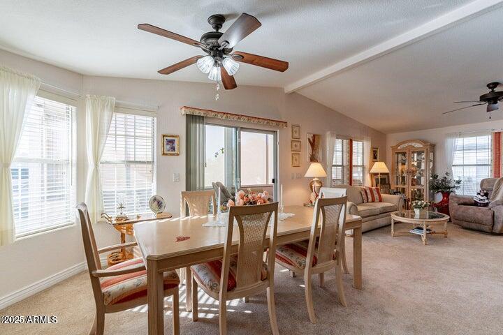 201 South Greenfield Road, Unit 176 Mesa, AZ 85206 - Photo 26 of 61 a view of a dining room with furniture a chandelier and large windows