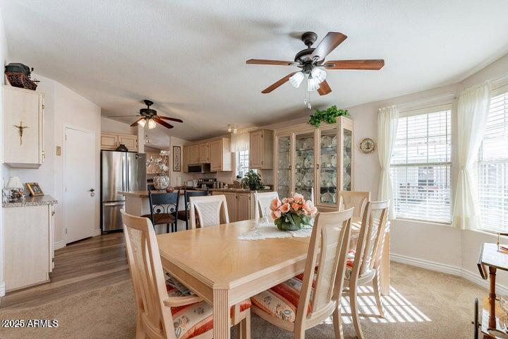 201 South Greenfield Road, Unit 176 Mesa, AZ 85206 - Photo 28 of 61 a view of a dining room with furniture window and wooden floor