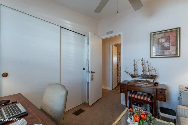 a living room with lots of furniture and kitchen view