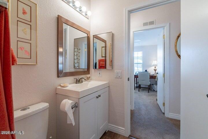 201 South Greenfield Road, Unit 176 Mesa, AZ 85206 - Photo 32 of 61 a bathroom with a toilet sink and mirror