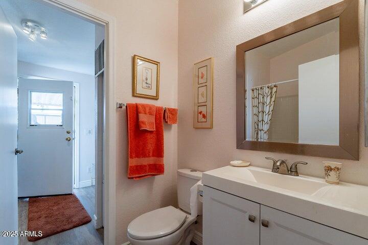 201 South Greenfield Road, Unit 176 Mesa, AZ 85206 - Photo 33 of 61 a bathroom with a toilet a sink a mirror a vanity and shower