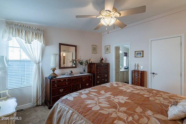 201 South Greenfield Road, Unit 176 Mesa, AZ 85206 - Photo 37 of 61 a bedroom with a bed and a chandelier