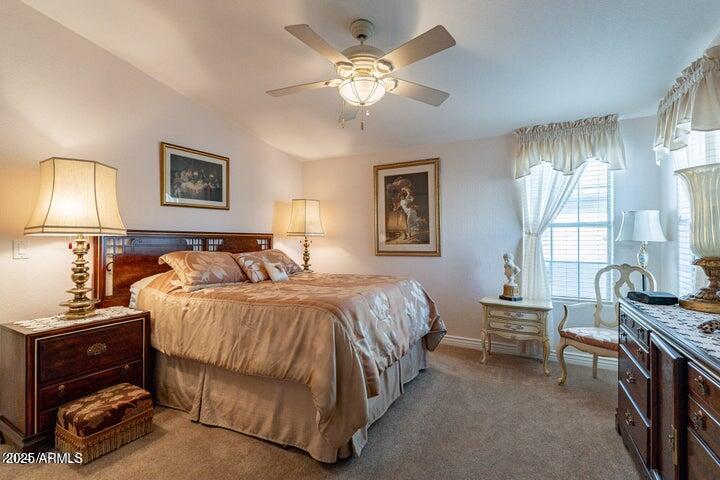 201 South Greenfield Road, Unit 176 Mesa, AZ 85206 - Photo 4 of 61 a bedroom with a bed and a chandelier