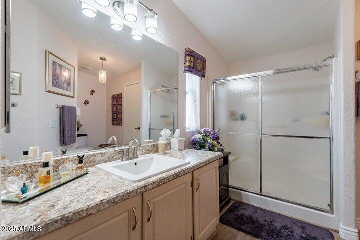 201 South Greenfield Road, Unit 176 Mesa, AZ 85206 - Photo 5 of 61 a bathroom with a granite countertop sink a shower and a mirror