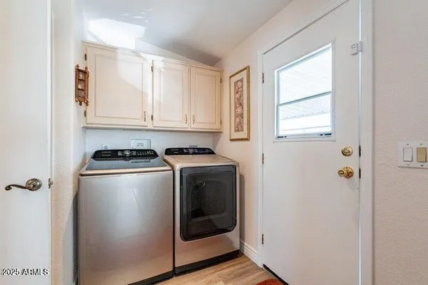 a living room with furniture and a painting on the wall