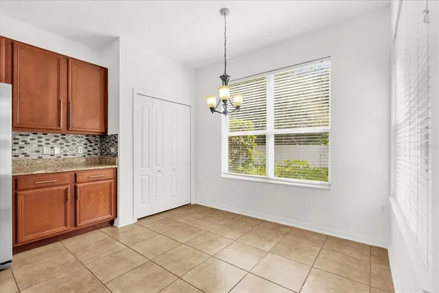 a large kitchen with stainless steel appliances granite countertop a stove a sink dishwasher and a large window