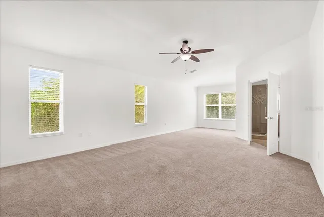 a view of a room with a ceiling fan