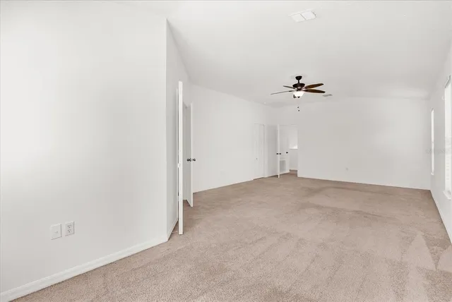a large white bathroom with a sink mirror and bathtub