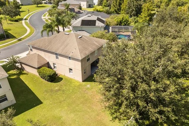 an aerial view of residential houses with outdoor space