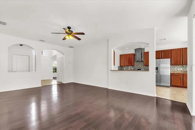 a view of kitchen with granite countertop cabinets and window