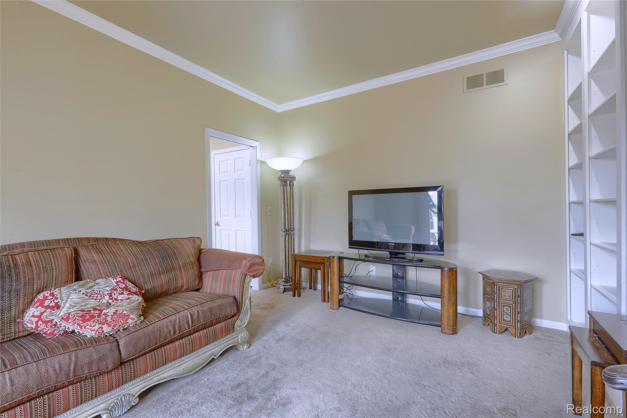 2007 Mapleridge Road Rochester, MI 48309 - Photo 20 of 45 Living room with crown molding and carpet floors