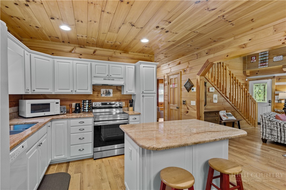339 Welcome Way Boone, NC 28607 - Photo 7 of 20 a kitchen with granite countertop a sink a counter space appliances and cabinets
