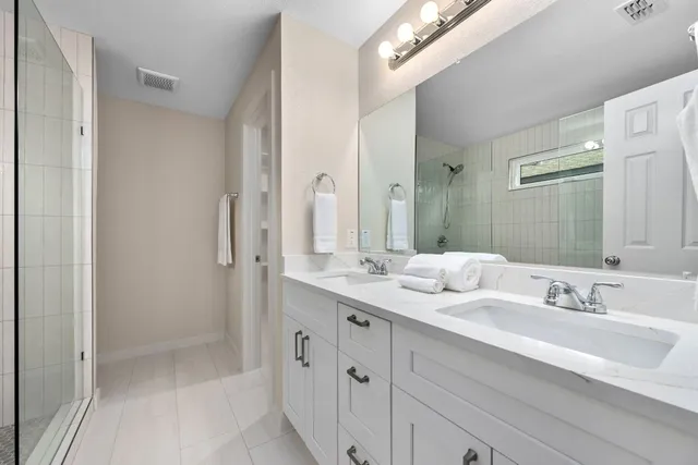 a bathroom with a sink double vanity and a mirror